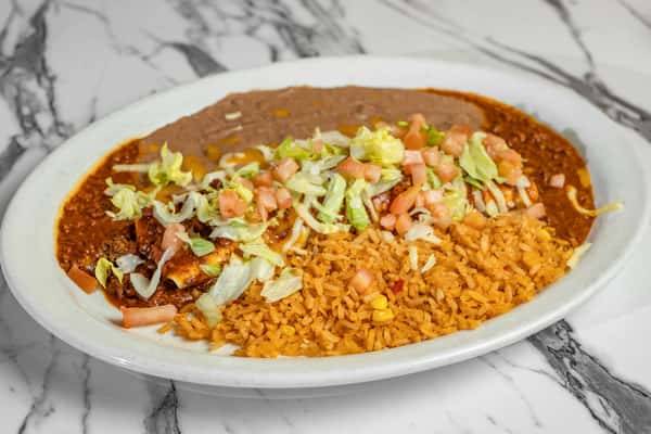 Savory enchiladas smothered in chili sauce and topped with shredded lettuce and pico de gallo, served alongside Mexican rice and refried beans.