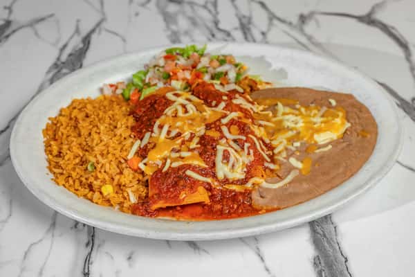 Traditional Mexican enchiladas topped with red sauce and shredded cheese, served with Mexican rice, refried beans, and fresh pico de gallo.