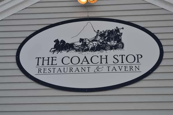 Oval sign saying "The Coach Stop Restuarant & Tavern"