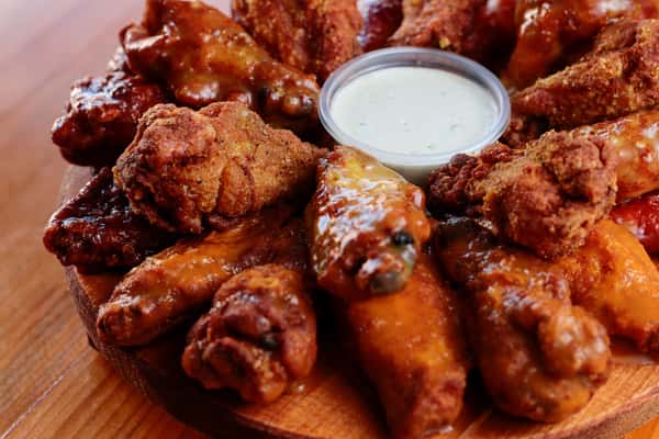 Assorted crispy chicken wings tossed in flavorful sauces and served with a side of creamy ranch dressing.