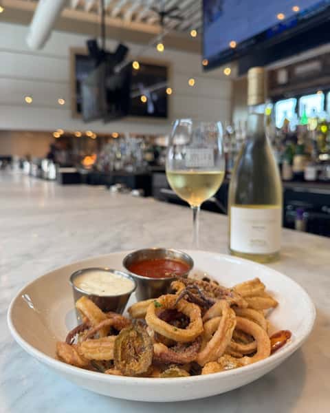 Perfectly tender, crispy fried calamari, a refreshing glass of Vermentino.... all that's missing from this picture is you!