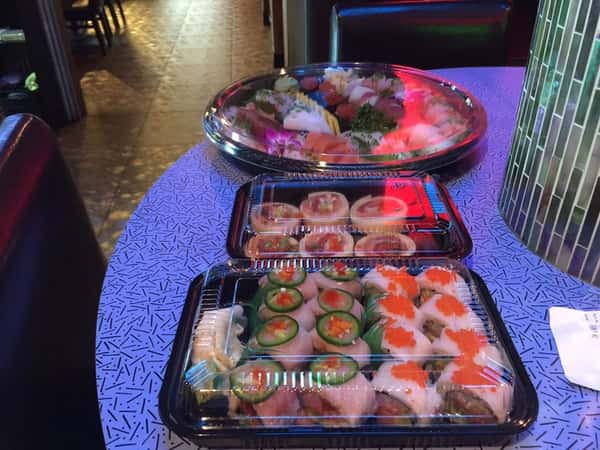 large takeout containers of sushi