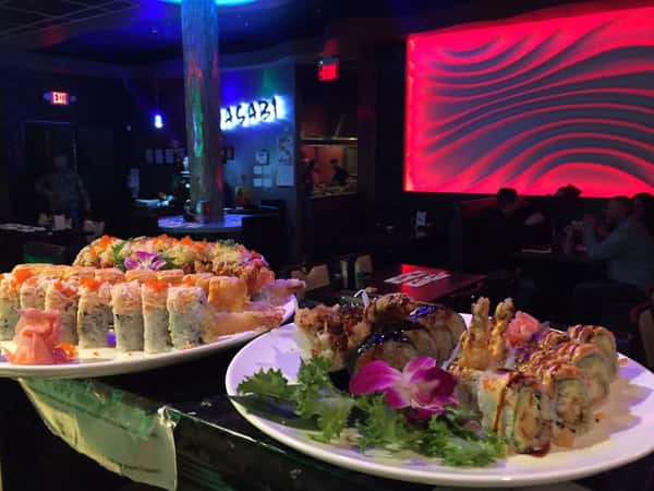 two platters of sushi rolls