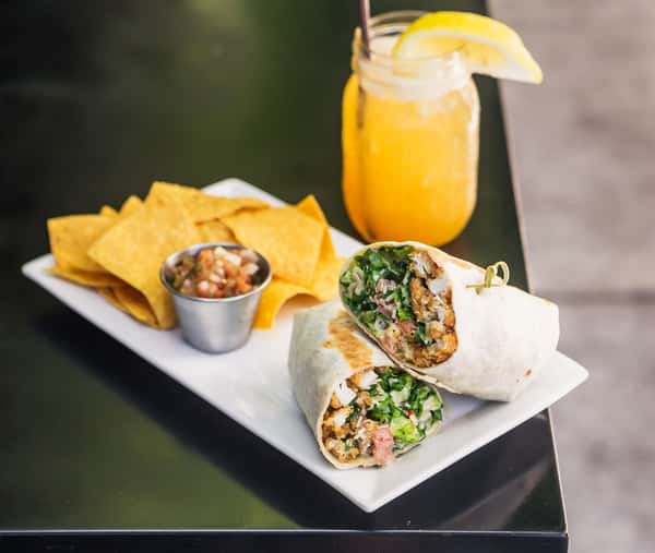A classic staple on our massive menu is the chicken caesar wrap along with a refreshing cocktail