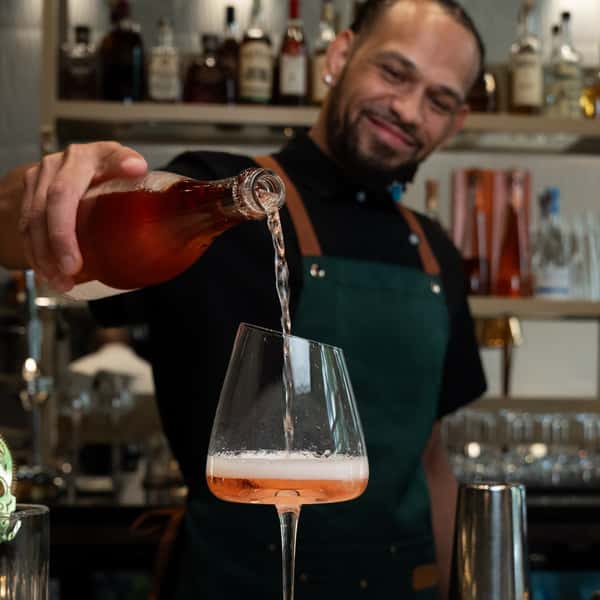 Man pouring drink in a glass