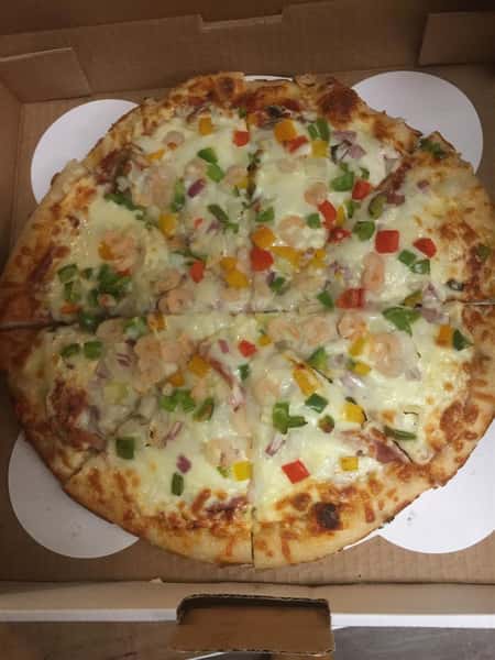 Pizza with cheese, tomatoes, onions, peppers in carboard box