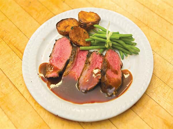 sliced steak with vegetables and potatoes