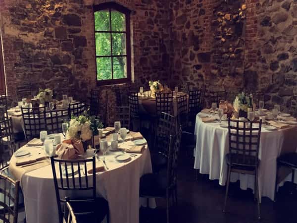 banquet tables set inside stone walled room