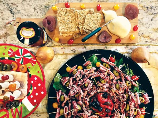 skewers on a platter and a meat and cheese platter