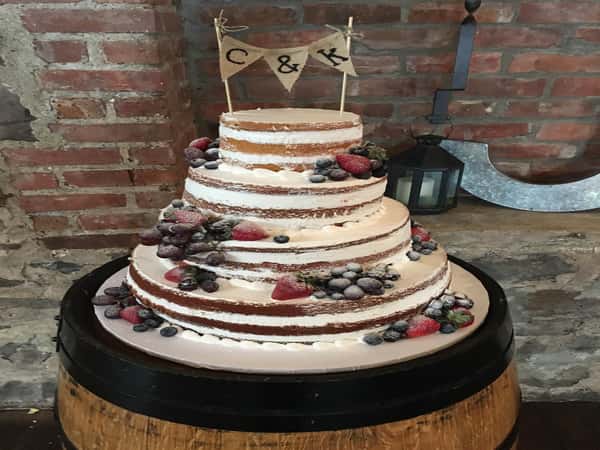 naked cake topped with strawberries and blueberries