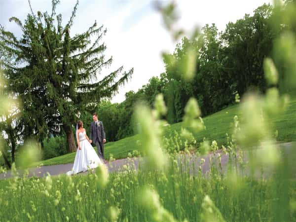 bride and groom walking down pathway