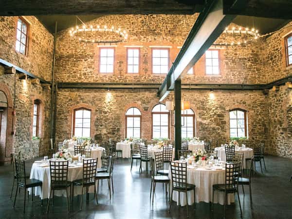 interior of brotherhood winery showcasing large chandeliers and stone walls
