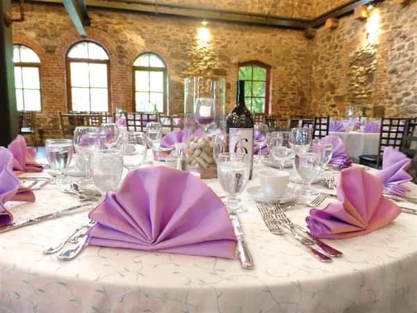 banquet table set with purple linens
