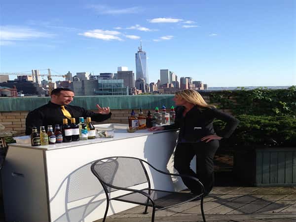 bar set on rooftop with new york skyline in background