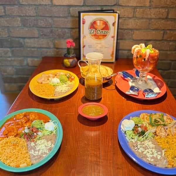 Signature Mexican dishes at El Cazo Mexican Restaurant featuring shrimp entrées, rice, refried beans, fresh salad, shrimp cocktail, chips and salsa, and house-made salsa in a warm dining atmosphere.