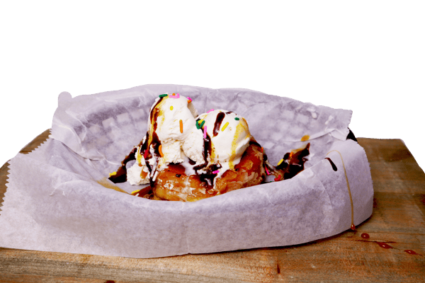 Hangry's Grill's scoop of ice cream sits atop a warm, golden-brown pastry drizzled with chocolate sauce.