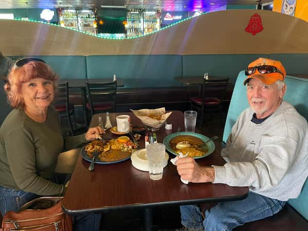 Couple sitting at a table within La Cascada