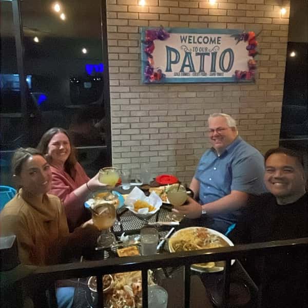 Family sitting at a patio table at La Cascada