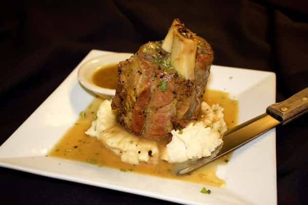 grilled filet over mashed potatoes topped with sauce