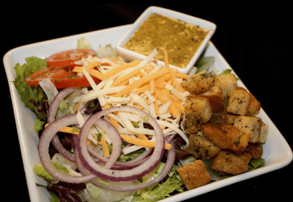 salad with onions, tomatoes, shredded cheese, and croutons