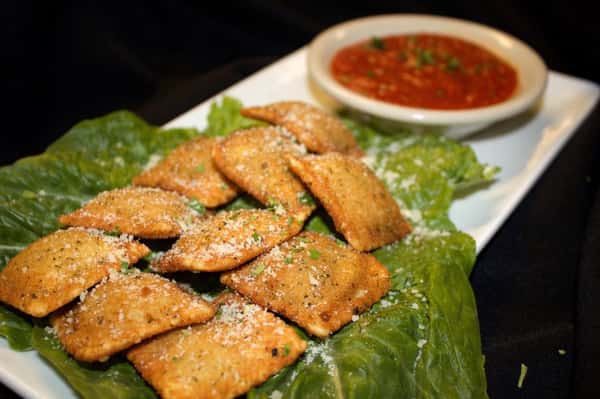 fried ravioli with a side of dipping sauce
