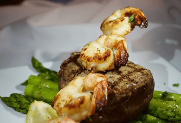 grilled steak topped with grilled shrimp