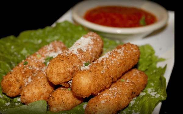 assortment of mozzarella sticks with a side of dipping sauce