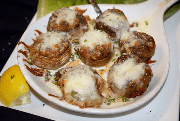 stuffed mushrooms topped with cheese and garnish
