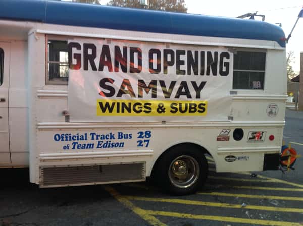 Truck with banner announcing Samvay's grand opening