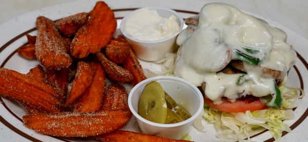 grilled chicken sandwich with sweet potato fries and pickles on the side