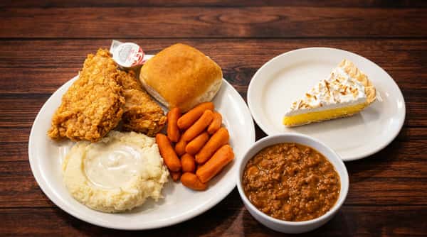 Don's Family Style Buffet with fried chicken, mashed potatoes, carrots, roll, chili, and lemon meringue pie.