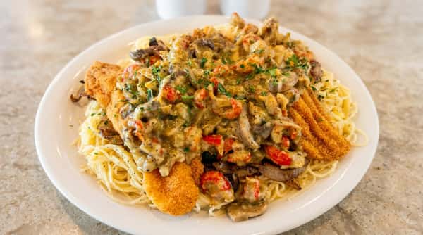 Fried fish with creamy crawfish pasta at Woody's Burgers and Bugs in Madison