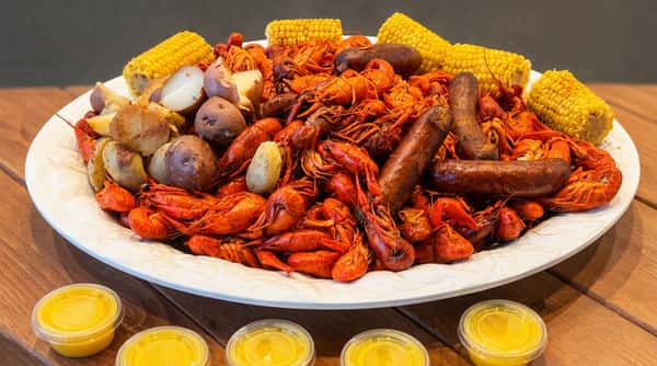 Cajun crawfish boil platter with sausage, corn and potatoes at Woody's Burgers and Bugs