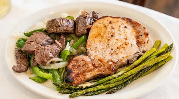 Grilled pork chop with asparagus and Southern sides at Woody's Burgers and Bugs