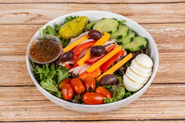 Discover a world of flavor with our Chef Salad! 🥗🍅 It's a symphony of fresh mixed greens, succulent turkey slices, sharp cheddar, crunchy cucumbers, sweet cherry tomatoes, vibrant red peppers and tangy olives. Finished off with a hard-boiled egg for that extra protein punch. Served with our house dressing to bring all these delightful flavors together. This is not just any salad, it's the Chef Salad at FK Nader's Classic Po'Boys! #FreshCrunch #ProteinPacked #FKPoBoys