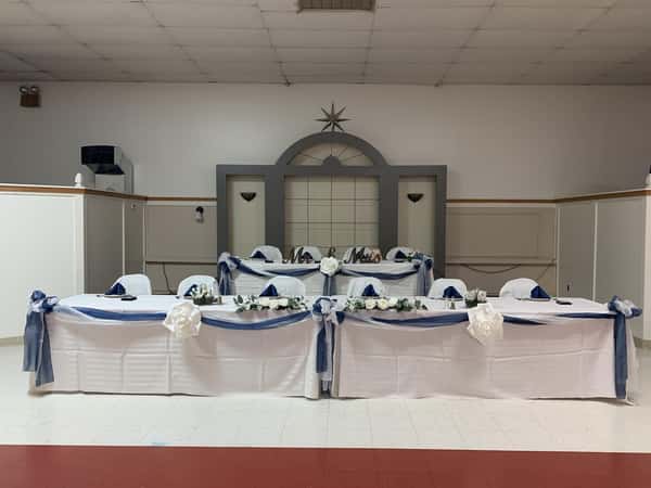 Three tables set with wedding decor.