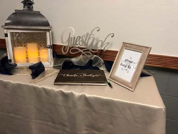 table topped with a guest book and decor