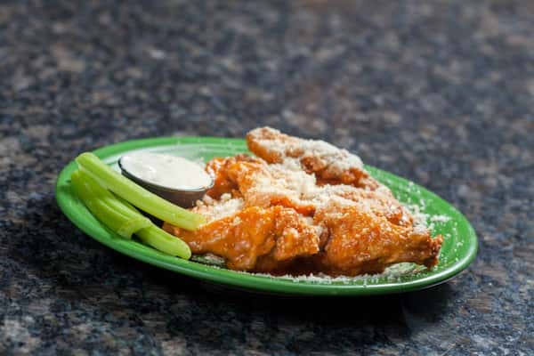 Buffalo chicken wings topped with grated cheese, celery and bleu cheese