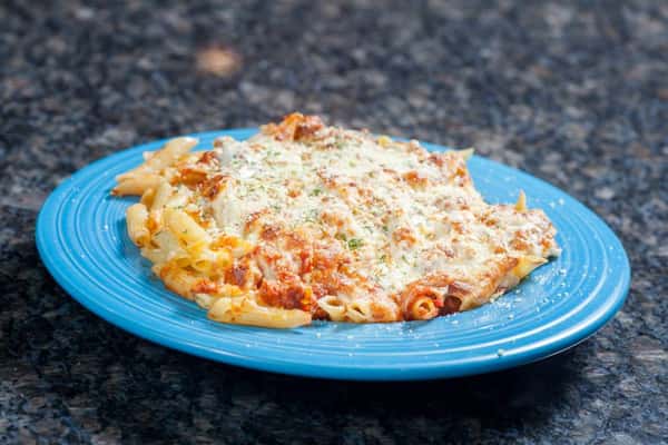 Penne pasta with cheese, sauce and grated cheese