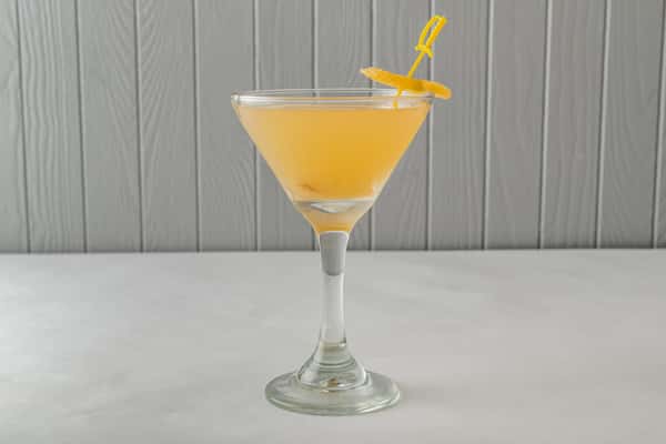 Chilled orange martini served in a classic cocktail glass, garnished with a citrus slice — a stylish and refreshing drink for happy hour or evening cocktails.