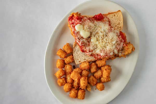 Crispy chicken parmesan sandwich topped with marinara sauce and melted mozzarella, served open-faced on Italian bread with a side of golden tater tots.