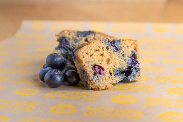 Mini blueberry muffins packed with juicy blueberries and baked fresh daily for breakfast, catering, and coffee pairings.