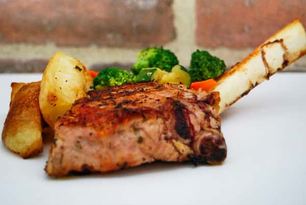 Grilled bone-in veal chop brushed with extra virgin olive oil and herbs
