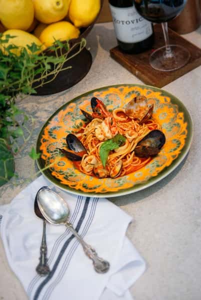 Spaghetti with wild shrimp, mussels, clams, and calamari in a light tomato broth