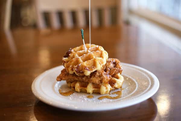 fried chicken with waffles as the buns on a plate