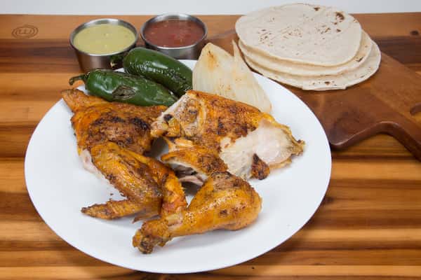 Mesquite charboiled half chicken (4 pieces), 2 sides 6oz, green and red sauce, tortillas, grilled onion and grilled jalapeño.