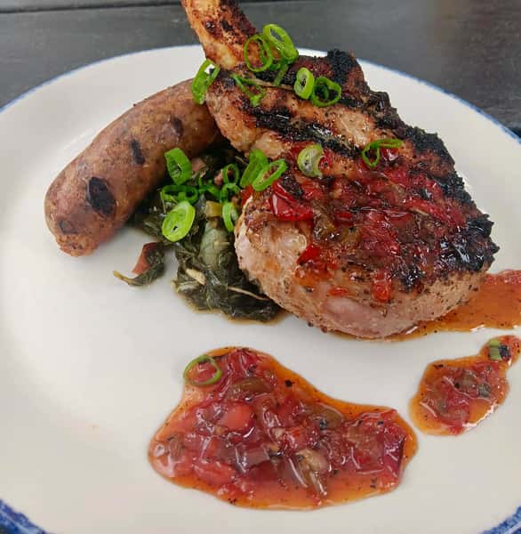 Grilled ribeye steak served over crispy smashed potatoes and wilted spinach, topped with shredded Parmesan and fresh herbs.