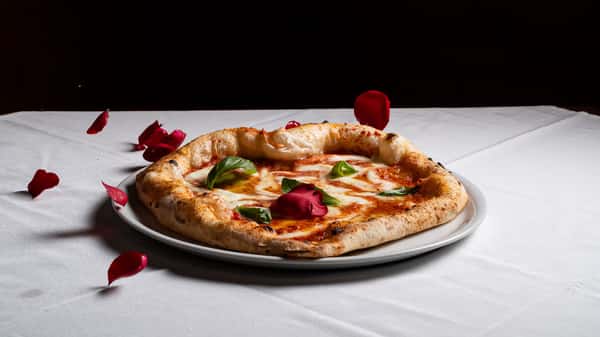 popmenu-a-beautifully-presented-margherita-pizza-with-fresh-basil-on-original.jpg