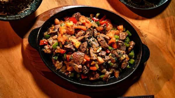 popmenu-delicious-grilled-beef-with-peppers-and-tomatoes-in-a-hot-sk-original.jpg