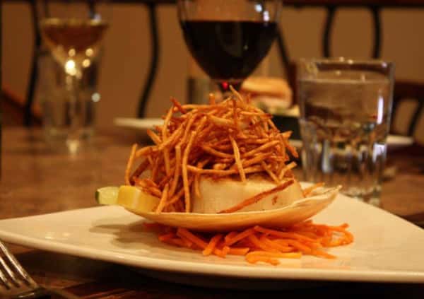 Entree with onion crisps and wine glass